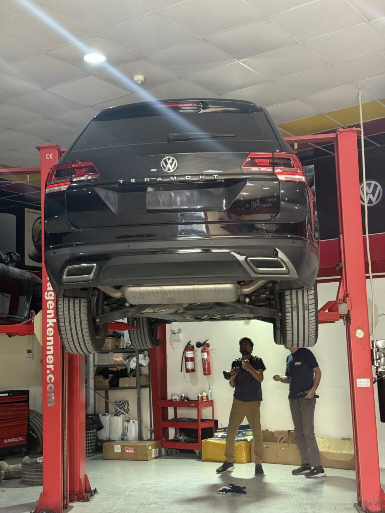 Rear view of a Volkswagen Teramont raised on a workshop lift at WagenKenner in Dubai