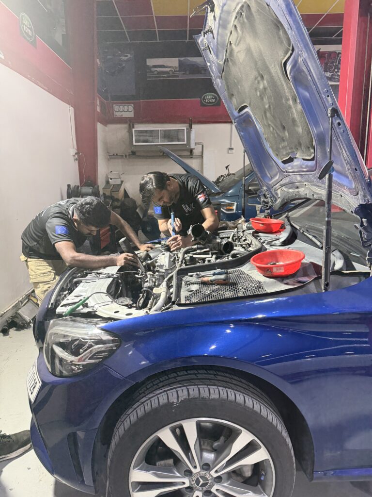 Technicians working in a Mercedes-Benz engine bay at WagenKenner in Al Quoz, Dubai