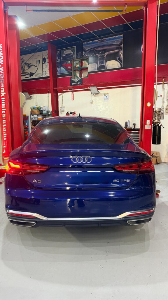 Rear view of a blue Audi A5 at WagenKenner workshop in Al Quoz 4, Dubai