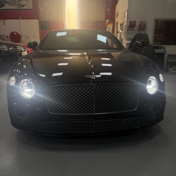 Front view of a black Bentley Continental GT at WagenKenner workshop in Al Quoz 4, Dubai