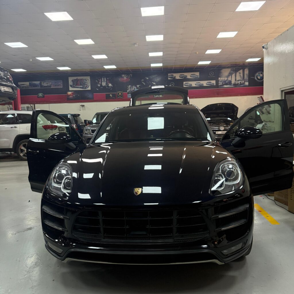 Front view of a black Porsche Macan at WagenKenner workshop in Al Quoz 4, Dubai